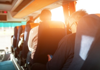 Interior of a bus rental with passengers sitting in seats