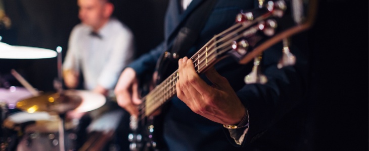 close up of a performer playing guitar at an event